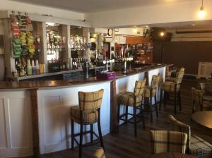 een bar met een stel barkrukken bij Queensberry arms hotel in Kirkconnel