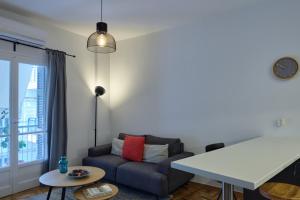 uma sala de estar com um sofá e uma mesa em K1 Apartment em Atenas