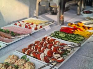 a buffet with several plates of food on a table at Willa Czarnieckiego in Warka