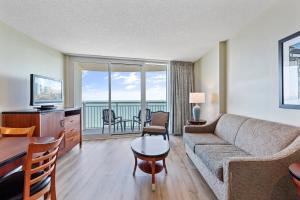 a living room with a couch and a table at Sandy Beach Resort in Myrtle Beach