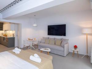 a living room with a couch and a kitchen at Electra Luxury Apartment at the Heraklion Center in Heraklio