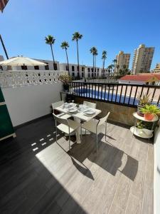 a patio with a table and chairs on a balcony at Apartment Soleil Altamar in Playa de las Americas