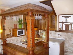 a kitchen with a wooden counter top in a kitchen at Casa Carabias in Carabias