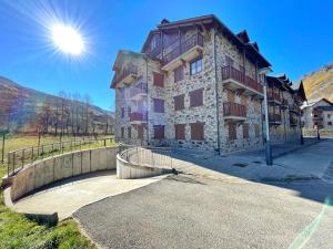 a large stone building with a bridge in front of it at Apartamento Valle de Alba in Benasque