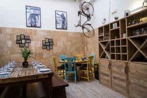 a dining room with a table and chairs and a bike on the wall at Blanca Boutique Hotel in Jávea