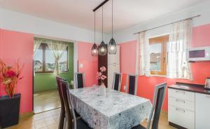 a kitchen and dining room with a table and chairs at Spacious new app for 5 persons, close beach&city in Poreč