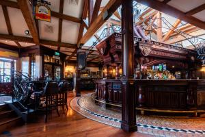 a bar in a pub with wooden floors and ceilings at Da Vinci's Hotel in Derry Londonderry