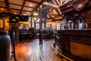 a pub with a bar with chairs and a counter at Da Vinci's Hotel in Derry Londonderry +20 photos