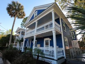 a blue and white house with a palm tree at Villa Mulvey #1 in Saint Augustine