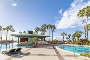 a resort pool with palm trees and a gazebo at Royal Savoy - Ocean Resort - Savoy Signature in Funchal