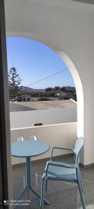 a table and a chair and a table and a table and a window at Loukia Apartments & Studios in Naousa