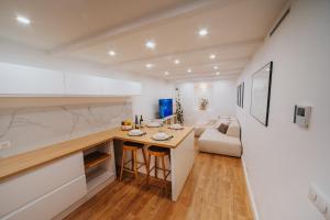 a kitchen and living room with a table and a couch at Perfect family-oriented and renovated townhouse in the old Antibes in Antibes +43 photos