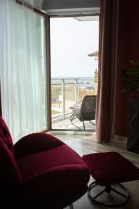 a living room with a couch and a large window at APARTAMENT ELEGANCE RED w Let's Sea in Gąski