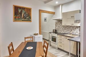 a kitchen with a wooden table and a table and chairs at Krejčovství in Mělník