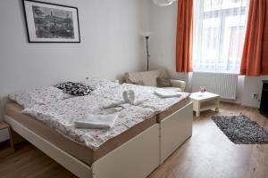 a bedroom with a bed with towels on it at Krejčovství in Mělník