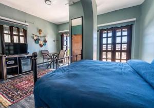 ein Schlafzimmer mit einem blauen Bett und einem TV in der Unterkunft Liman Deluxe Hotel in Marmaris