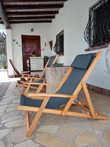 a group of lounge chairs sitting on a patio at VILLA LUPINO in Orosei
