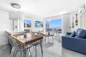 a living room with a blue couch and a table at Veracruz 20-E in Benidorm