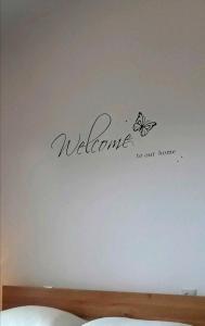 a welcome to our home sign on a wall at Rooms Ankica in Primošten