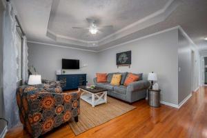 a living room with a couch and a table at Single-Story Manchester Home Close to Parks! in Manchester