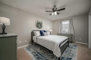 a bedroom with a bed and a ceiling fan at Single-Story Manchester Home Close to Parks! in Manchester