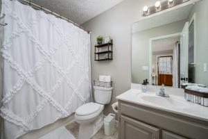 a bathroom with a toilet and a sink and a mirror at Single-Story Manchester Home Close to Parks! in Manchester +20 photos