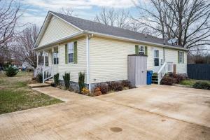 a white house with a garage and a driveway at Single-Story Manchester Home Close to Parks! in Manchester