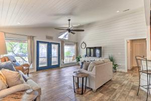 a living room with couches and a ceiling fan at Charming Burnet Cottage with Lake View and Porch! in Burnet