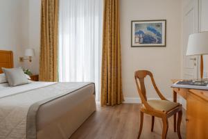 Postel nebo postele na pokoji v ubytování Residenza Parco Fellini