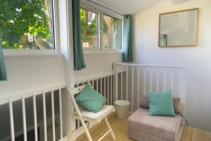 a living room with a couch, chair and a window at Largigi, Free Parking, Close to the Beach and Town Centre Rooms in Lyme Regis
