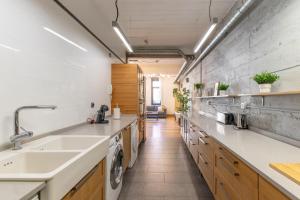 a kitchen with a sink and a washing machine at NEW! Lovely 3-Bedroom Loft in Bilbao in Bilbao