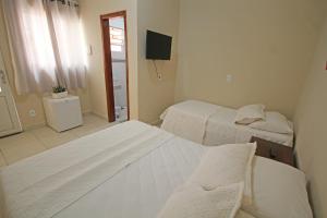 מיטה או מיטות בחדר ב-Recanto Villa REAL
