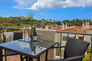 a table with a bottle of wine on a balcony at 2BR Duplex Townhouse with access to Pool - 5mn to Beach by LovelyStay in Ferragudo