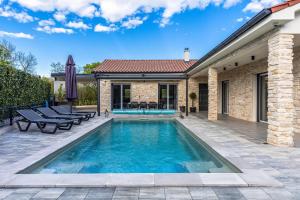 a swimming pool in the backyard of a house at Villa Larra in Gostinjac