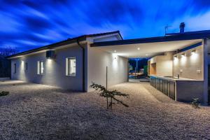 a rendering of a house at night at Villa Larra in Gostinjac