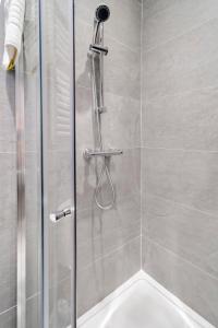 a shower with a glass door in a bathroom at Magee Town House 'Sleeping 8 guests' in Londonderry County Borough +23 photos