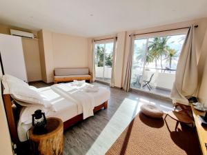 a hotel room with a bed and a large window at Lea Spa Hotel in Maafushi