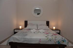 a bedroom with a large bed with two candles on it at Vera in Zadar