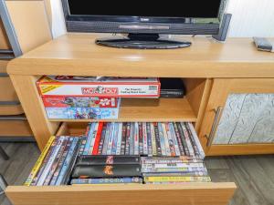 a book shelf filled with video games and dvds at 103 Cherry Park in Skegness