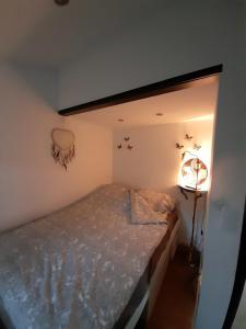 a small bedroom with a bed in a room at Haus mit Blick auf den Lister See in Meinerzhagen