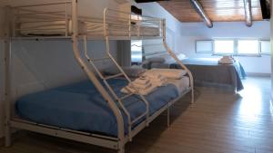 a bedroom with two bunk beds in a room at Pepi B&B in Santa Maria di Castellabate