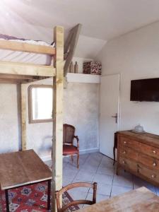 a room with a bunk bed and a table and a chair at Chez Beroy in Morlaas