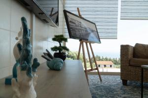 a living room with a table with a painting on it at Casa Pinha in Figueira da Foz