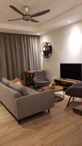 a living room with a couch and a flat screen tv at Cristalina's Little Apartment in Willemstad