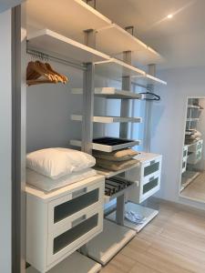 a walk in closet with white shelves at Casa da Mondina Comporta in Comporta