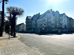 a street with a large building on the side of the road at Apartament Opal - ul. Grunwaldzka przy plaży in Pobierowo
