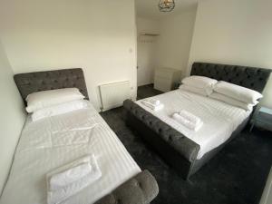 two beds sitting next to each other in a bedroom at Memorial Building in Ruthin