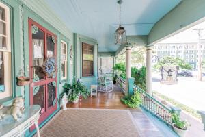 a house with a dog sitting on the front porch at Captain Mey's Inn in Cape May