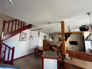 a kitchen and a living room with a stone fireplace at Le Passage in Concarneau