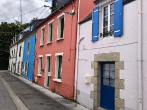 a row of colorful houses on a street at Le Passage in Concarneau